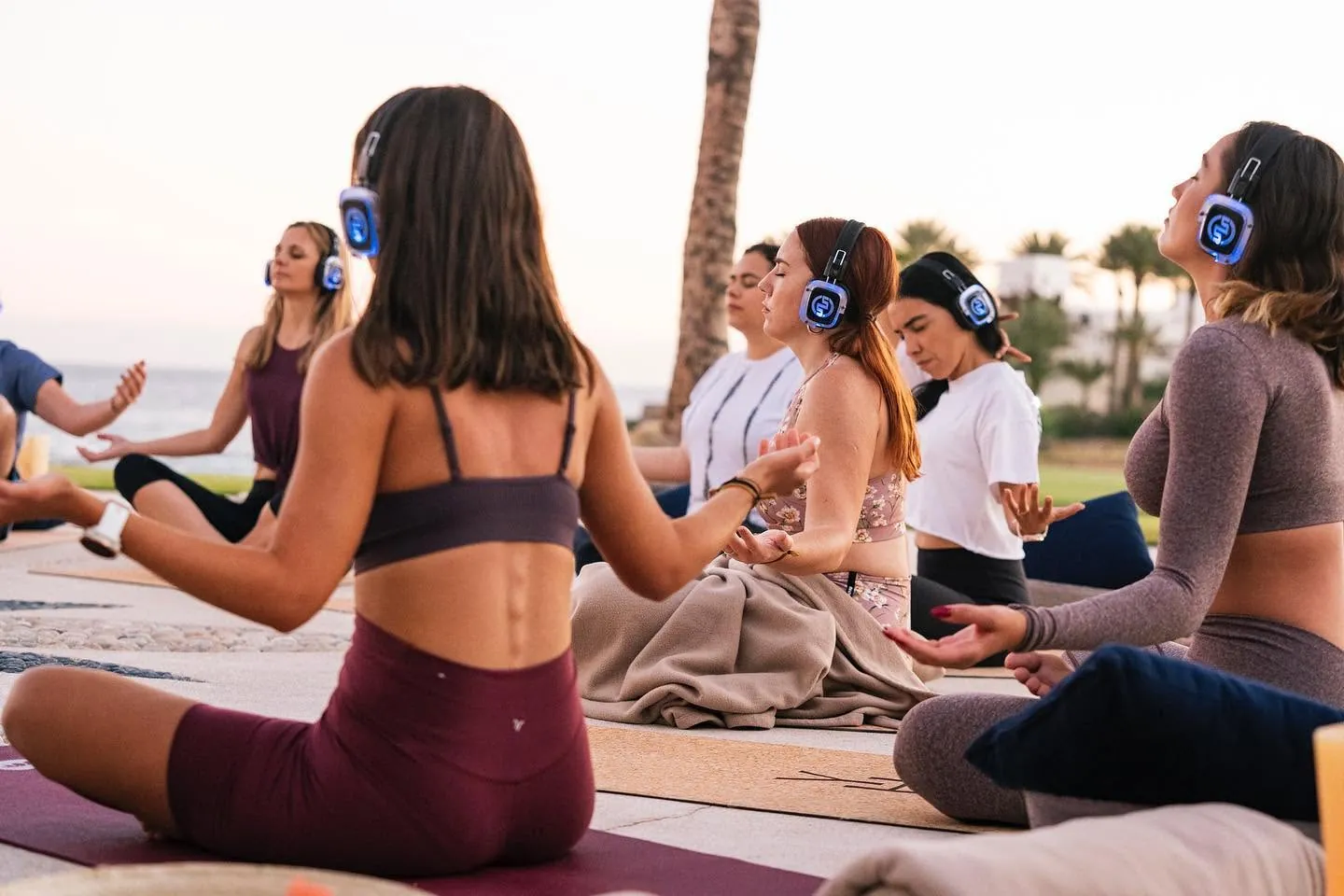 Sunset meditation at a resort, with glowing wireless headphones