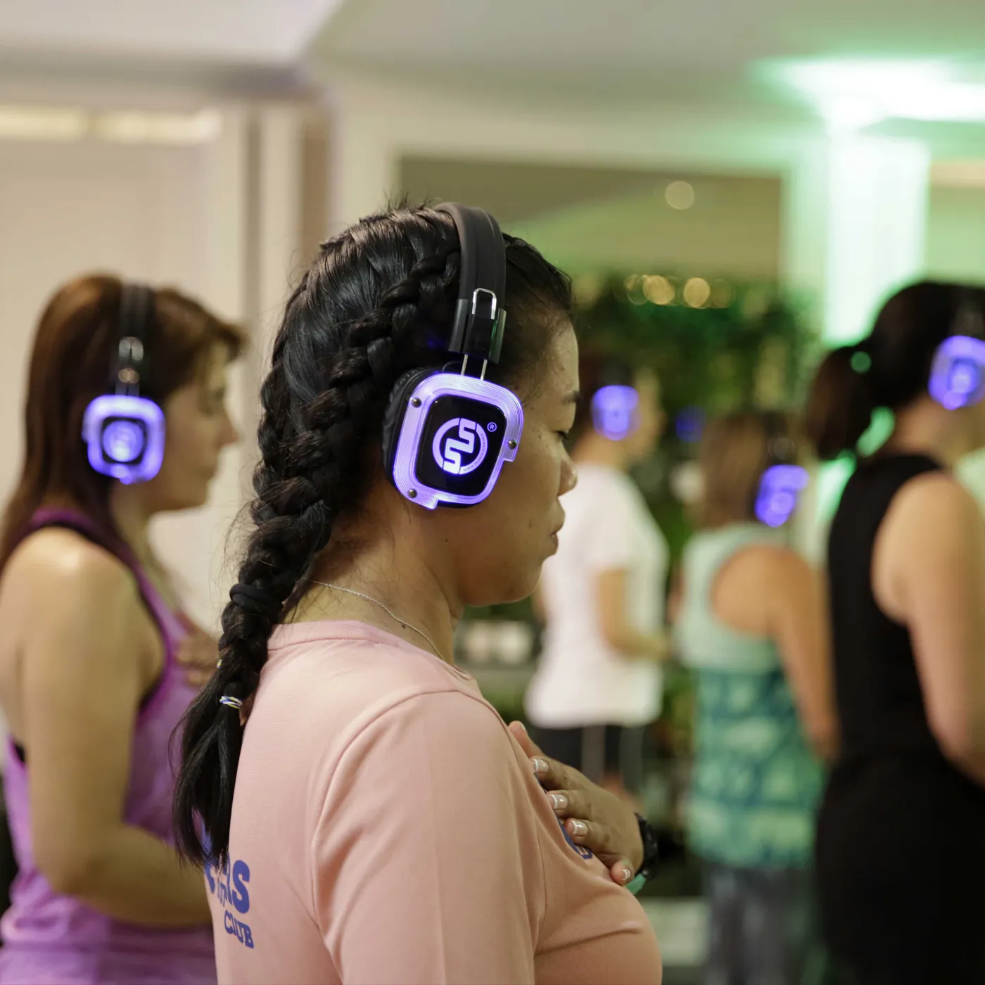 Standing breathing practice with glowing wireless headphones